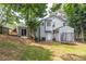 View of a spacious backyard featuring a deck, a trampoline, and a well-maintained lawn at 2320 Boone Pl, Snellville, GA 30078