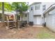 Backyard with a two level yard, patio and stairs leading to more backyard, and storage area under the 2nd level at 2320 Boone Pl, Snellville, GA 30078