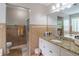 Well-lit bathroom featuring granite countertops, and a glass-enclosed shower at 2320 Boone Pl, Snellville, GA 30078