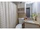 Cozy bathroom featuring a shower with curtain, granite vanity, and tiled walls for a comfortable and stylish space at 2320 Boone Pl, Snellville, GA 30078
