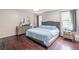 Relaxing bedroom with hardwood floors, soft lighting, and a comfortable bed at 2320 Boone Pl, Snellville, GA 30078