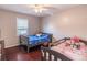 Cozy bedroom with hardwood floors, natural light, and playful decor at 2320 Boone Pl, Snellville, GA 30078
