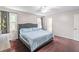 Bedroom features hardwood floors, soft lighting, comfortable bed, and bright windows at 2320 Boone Pl, Snellville, GA 30078