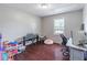 Bedroom featuring hardwood floors, bright windows, and space for a home office setup at 2320 Boone Pl, Snellville, GA 30078