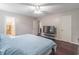 Comfortable bedroom with hardwood floors, soft lighting, and attached bathroom at 2320 Boone Pl, Snellville, GA 30078