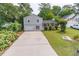 Inviting home with landscaped front yard, long driveway and welcoming covered porch at 2320 Boone Pl, Snellville, GA 30078