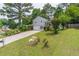 Landscaped front yard with long driveway leading up to a home with an inviting covered porch at 2320 Boone Pl, Snellville, GA 30078
