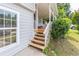 Inviting porch with wooden steps and charming details at 2320 Boone Pl, Snellville, GA 30078