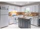 Bright kitchen with white cabinetry, stainless steel appliances and granite countertops at 2320 Boone Pl, Snellville, GA 30078