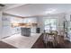 Bright kitchen features a movable island, white appliances, and an adjacent dining area at 2320 Boone Pl, Snellville, GA 30078