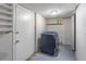 Practical laundry room with a modern washer and dryer, convenient shelving, and a service door at 2320 Boone Pl, Snellville, GA 30078