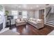 Spacious living room featuring dark hardwood floors, a fireplace, and natural light at 2320 Boone Pl, Snellville, GA 30078