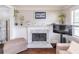 Bright living room features a decorative fireplace and dark hardwood floors at 2320 Boone Pl, Snellville, GA 30078