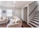 Comfortable living room with hardwood floors and access to the home's staircase at 2320 Boone Pl, Snellville, GA 30078