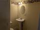 Cozy half-bathroom featuring a pedestal sink and classic fixtures at 345 Staten St, Jonesboro, GA 30238