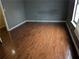 Spacious bedroom with dark wood laminate floors and neutral wall color at 345 Staten St, Jonesboro, GA 30238