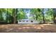Spacious backyard with mature trees and a white home in the distance at 4059 Canby Ln, Decatur, GA 30035