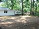 Spacious backyard featuring mature trees, a metal chain fence, and a white house, great for outdoor activities at 4059 Canby Ln, Decatur, GA 30035