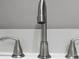 Modern brushed nickel faucet with lever handles on a white sink at 4059 Canby Ln, Decatur, GA 30035