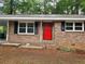 Charming brick facade featuring a bright red front door and black shutters at 4059 Canby Ln, Decatur, GA 30035