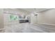 Bright, open-concept living space with gray floors connecting the kitchen at 4059 Canby Ln, Decatur, GA 30035