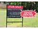 'For Sale' sign with open house details in a lush, green setting at 4059 Canby Ln, Decatur, GA 30035