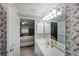 Charming bathroom with floral wallpaper, a vanity with a large mirror, and an open doorway to the bedroom at 1800 Clairmont Lk # 630, Decatur, GA 30033