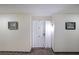 Apartment hallway with textured walls and art that leads to a bright white apartment front door at 1800 Clairmont Lk # 630, Decatur, GA 30033