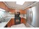Functional kitchen with oak cabinets, black appliances, and white countertops perfect for culinary endeavors at 1800 Clairmont Lk # 630, Decatur, GA 30033