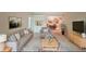 Inviting living room featuring stylish grey sofa set, built-in bookshelves, and view into the dining area at 1800 Clairmont Lk # 630, Decatur, GA 30033