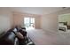 Spacious living room featuring a comfortable couch, large window, and a glimpse into the main bedroom at 1800 Clairmont Lk # 630, Decatur, GA 30033