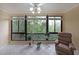 Bright sunroom with large windows offering serene views of nature, completed with a comfortable recliner at 1800 Clairmont Lk # 630, Decatur, GA 30033