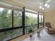Bright sunroom with large windows offering views of lush greenery and equipped with a ceiling fan at 1800 Clairmont Lk # 630, Decatur, GA 30033