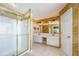 Spacious bathroom with a double vanity, a glass-enclosed shower, and marble-style walls at 2113 Soque River Dr, Duluth, GA 30097