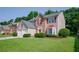 Well-maintained home featuring a two-car garage, brick accents, shutters, and a lush green lawn at 2113 Soque River Dr, Duluth, GA 30097