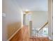 Light-filled hallway with hardwood floors leading to various rooms in the home at 2113 Soque River Dr, Duluth, GA 30097