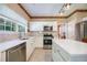 Well-lit kitchen featuring stainless steel appliances, white cabinets, and center island with quartz countertops at 2113 Soque River Dr, Duluth, GA 30097