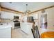 Modern kitchen featuring stainless steel appliances, white cabinets, central island and easy access to multiple rooms at 2113 Soque River Dr, Duluth, GA 30097