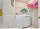 Well-lit laundry room featuring modern washer and dryer, shelving, and storage at 2113 Soque River Dr, Duluth, GA 30097