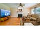 Cozy living room with hardwood floors, fireplace, ceiling fan and comfortable seating at 2113 Soque River Dr, Duluth, GA 30097