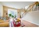 Bright living room featuring a bay window, staircase, hardwood floors, and neutral paint at 2113 Soque River Dr, Duluth, GA 30097