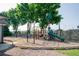 Community playground with various play structures, surrounded by green trees at 2113 Soque River Dr, Duluth, GA 30097