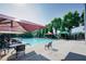 Community pool area featuring lounge chairs, umbrellas, and a clear blue swimming pool at 2113 Soque River Dr, Duluth, GA 30097