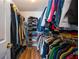 Organized walk-in closet with clothes neatly arranged on shelves and hanging racks at 2113 Soque River Dr, Duluth, GA 30097