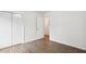 Bright bedroom featuring modern floors, white walls, and a closet with white doors at 329 Cranfill Se Rd, Marietta, GA 30060