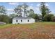 The exterior of this quaint house with a spacious, tree-lined backyard at 329 Cranfill Se Rd, Marietta, GA 30060