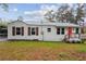 Charming single-story home featuring a bright red front door and a well-maintained lawn at 329 Cranfill Se Rd, Marietta, GA 30060