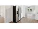 Stainless steel refrigerator in an open-concept kitchen area with hardwood floors at 329 Cranfill Se Rd, Marietta, GA 30060