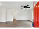 Bright living room featuring new floors, ceiling fan and a vibrant red door at 329 Cranfill Se Rd, Marietta, GA 30060