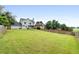 Expansive backyard featuring a lush lawn and a charming two-story home with a pergola at 3340 Deerwood Ln, Rex, GA 30273